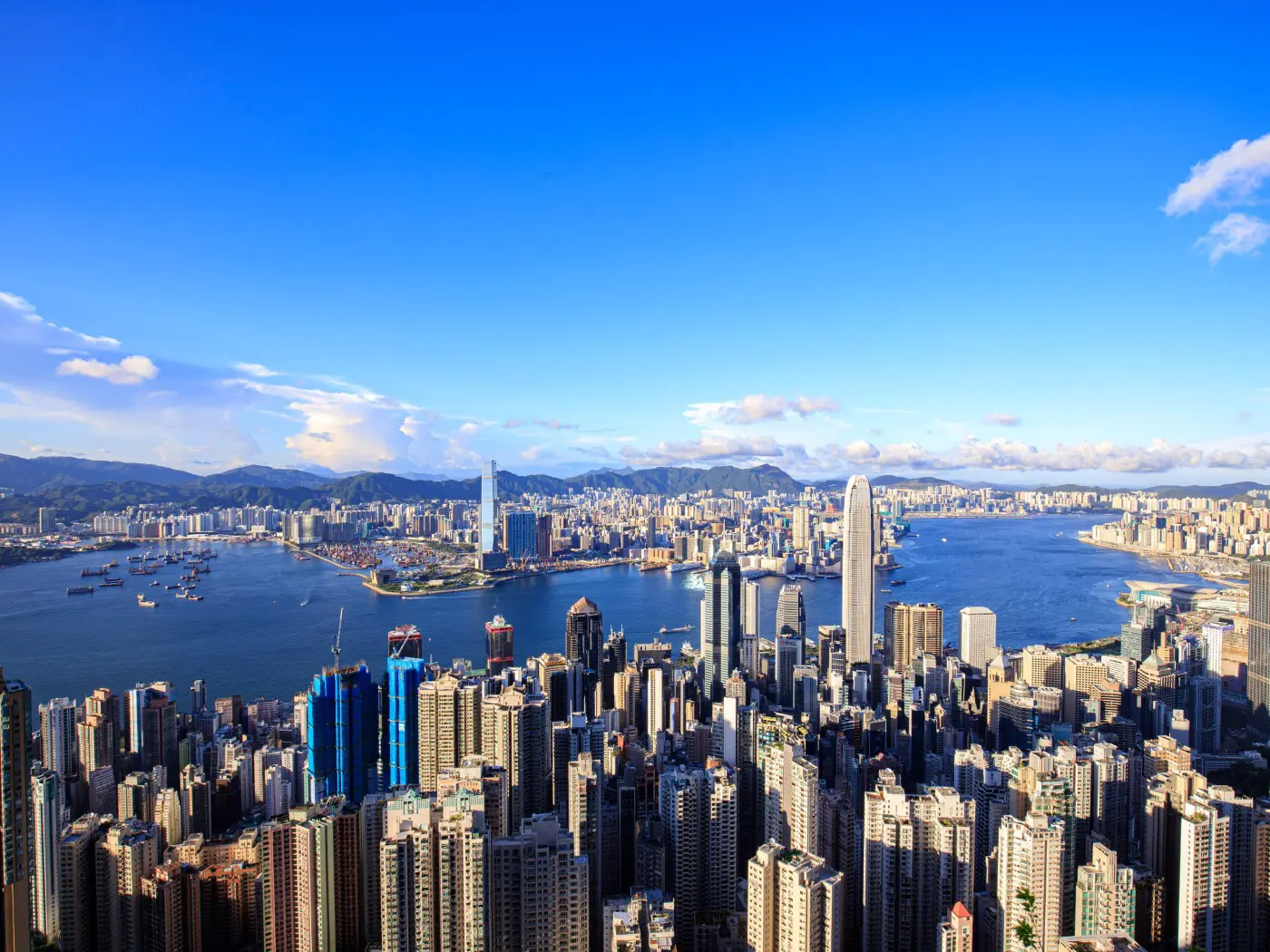 Hong Kong skyline with harbor and skyscrapers.