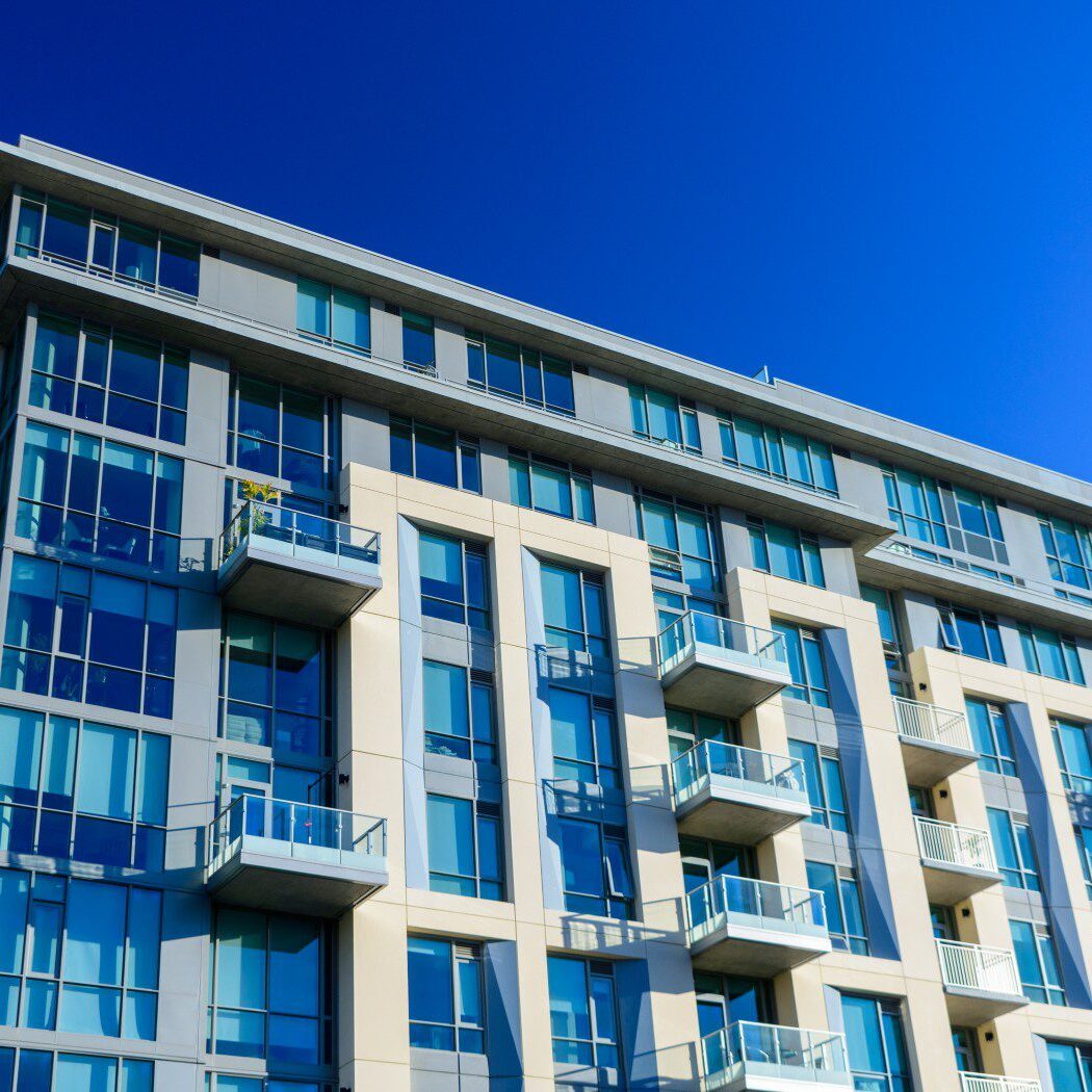 Modern apartment building with blue sky background.